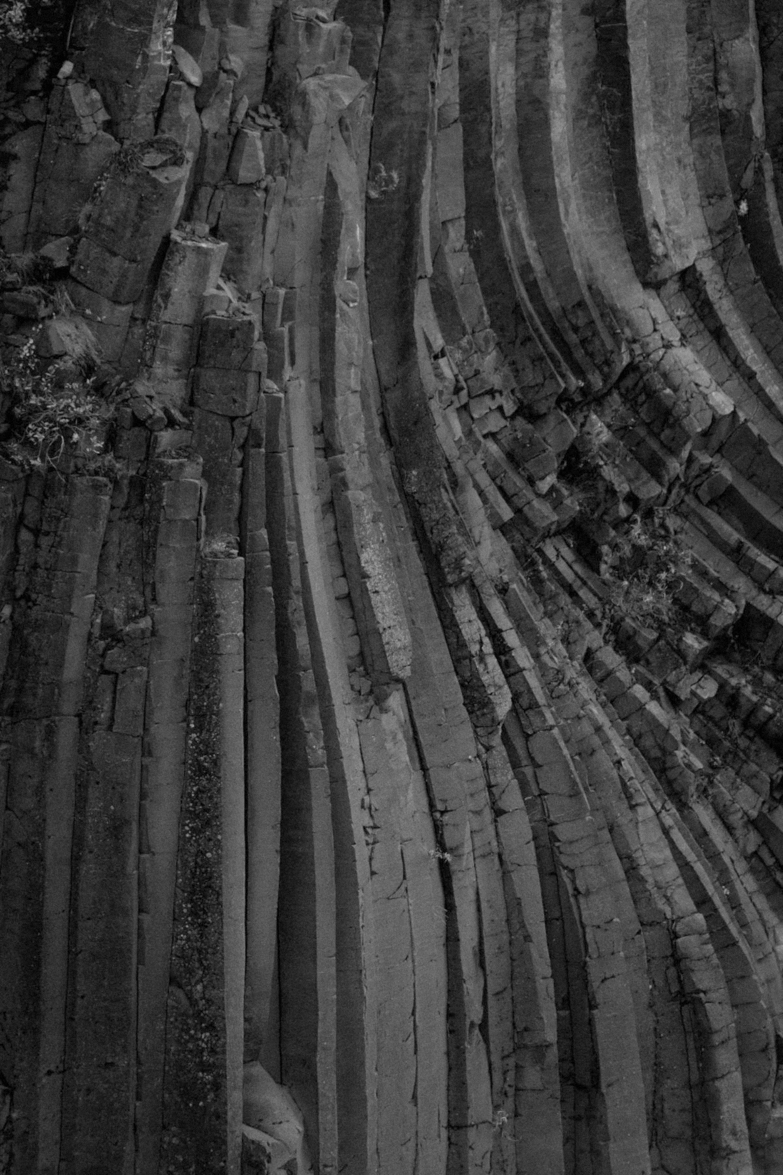A wall of natural columnar basalt rock