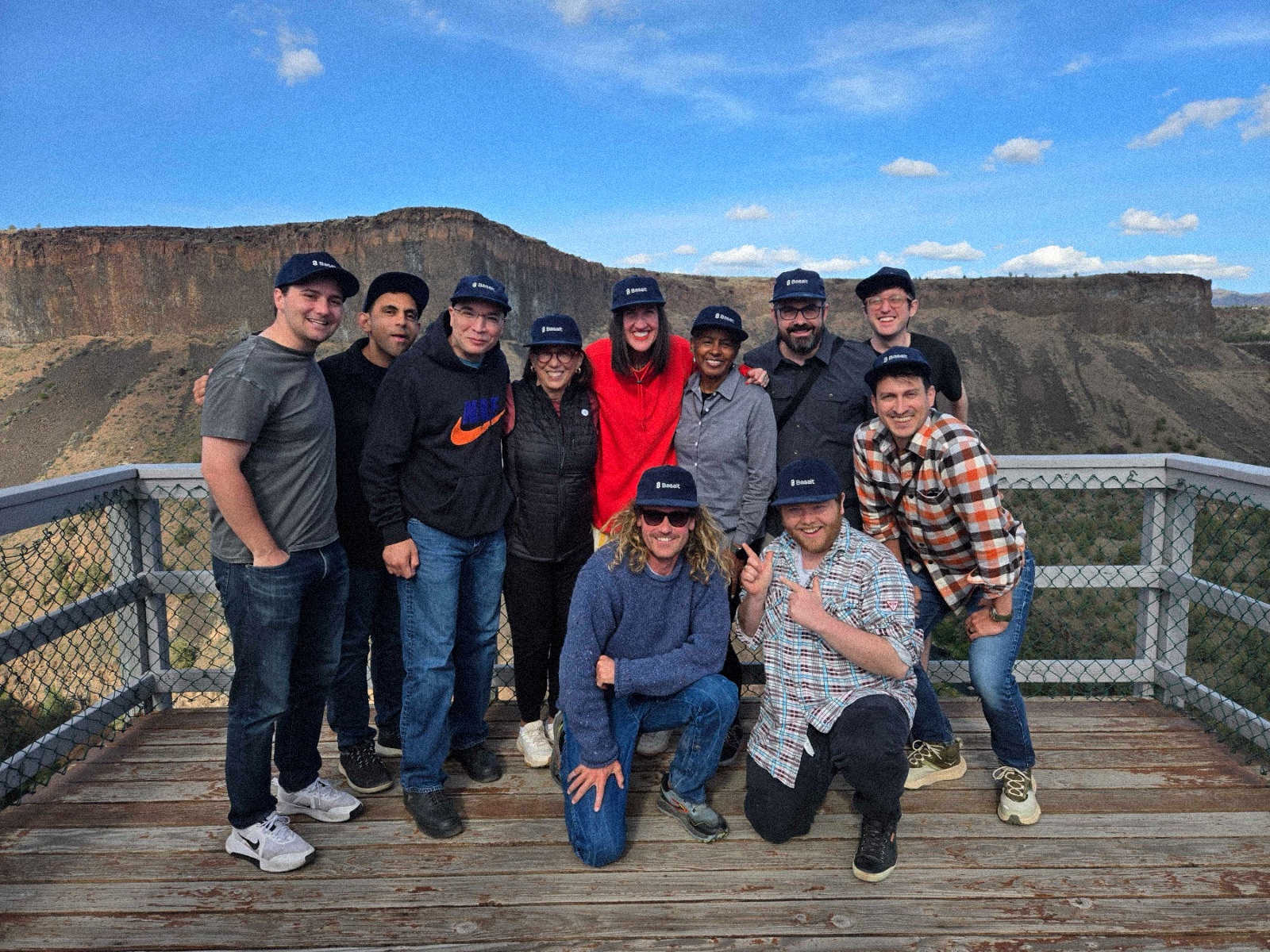 The Basalt team together at a canyon overlook, wearing Basalt caps